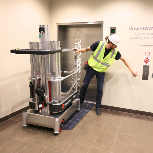 Worker loading a ReechCraft PowerLift into an elevator