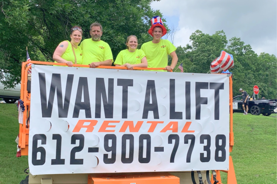2-Images-Article Want A Lift (1) The Want A Lift team poses in front of a parade float.